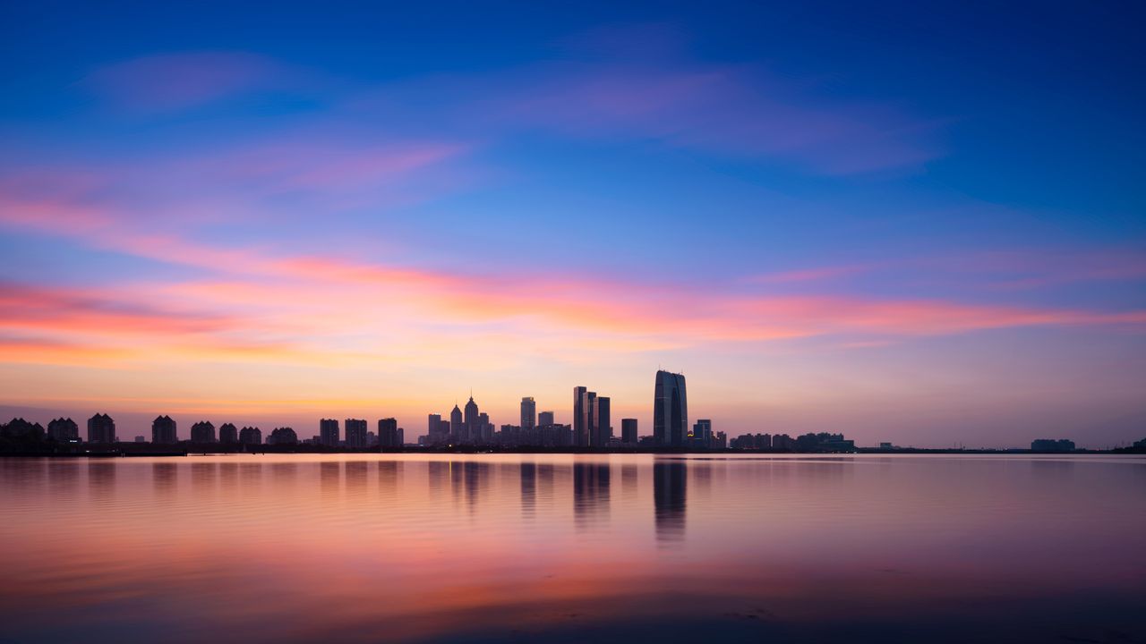 Skyscrapers reflected at sunset, Jinji Lake, Suzhou, China