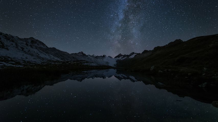 Stars reflecting in Totensee, a mountain lake at Grimsel Pass, Kanton Bern, Switzerland