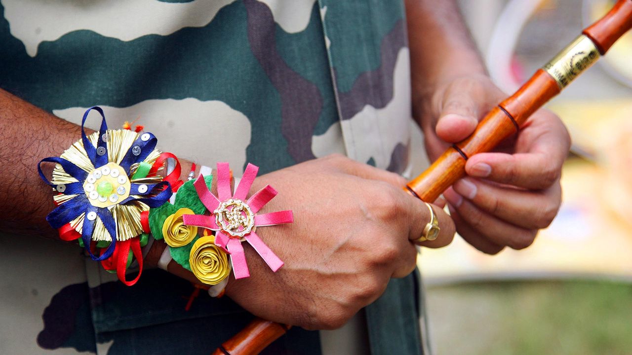 Officer wearing a rakhi on his wrist during rakshabandhan