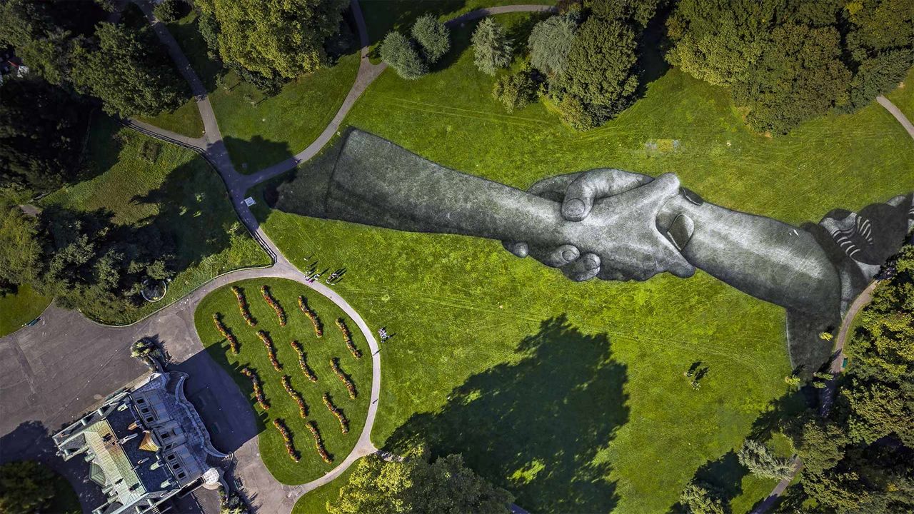 Artist Saype's 'Beyond Walls' installation in the Parc de la Grange, Geneva, Switzerland