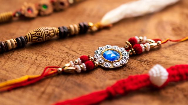 Handmade threads (rakhis) kept on a wooden surface