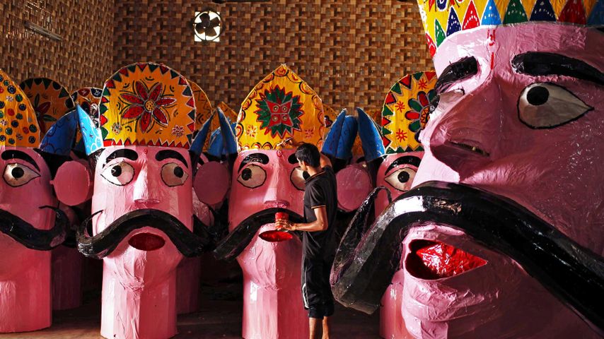 An artisan applies final touches to an effigy of Ravana in Jammu, India