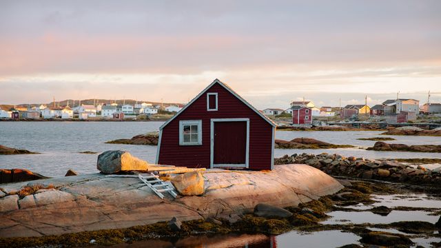 Small red house on the rocky coast of St. John's, Newfoundland and Labrador