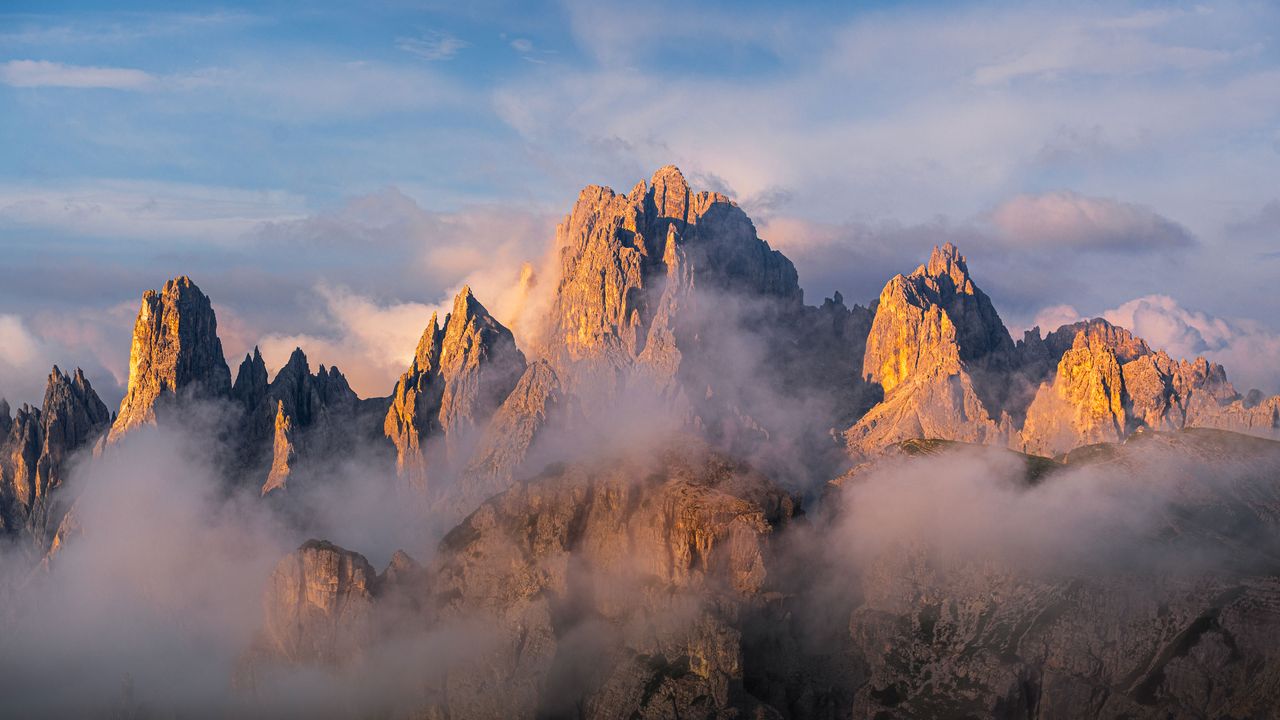 Sawtooth peaks emerging from fog, Cadini di Misurina, Dolomites, Italy