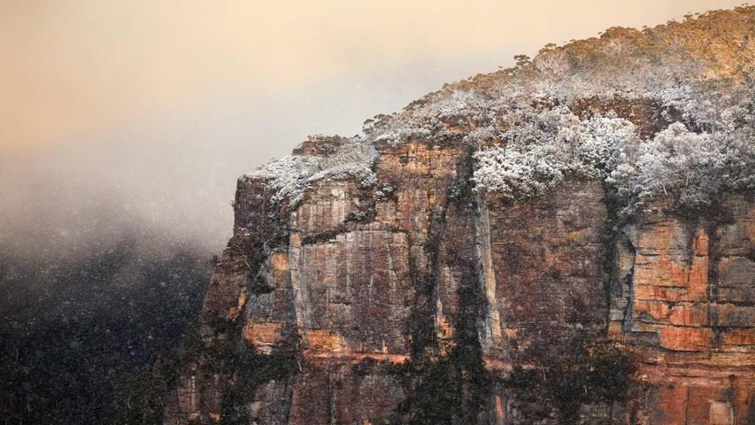 A snow-covered rocky cliff at Echo Point lookout, Katoomba, New South Wales