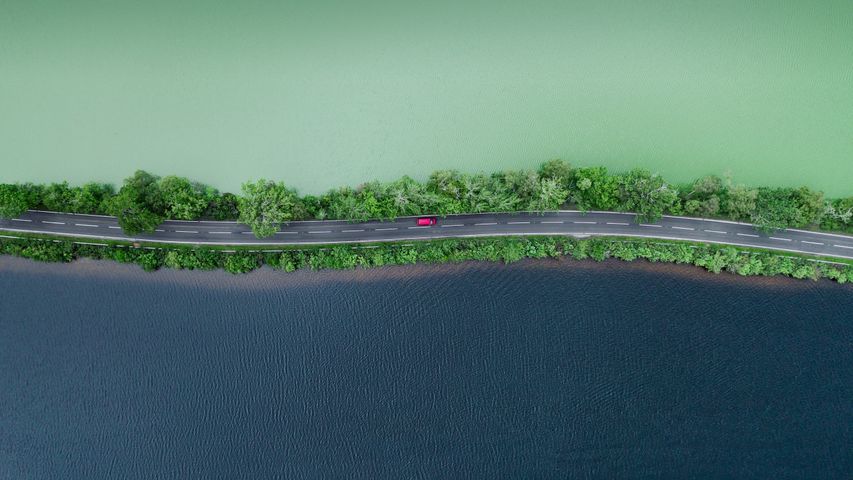 Aerial of a road separating two lakes in the Scottish Highlands