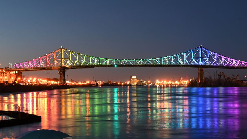 The Jacques Cartier bridge in Montreal is illuminated in the colours of the rainbow as a sign of hope and in support of the victims of the coronavirus