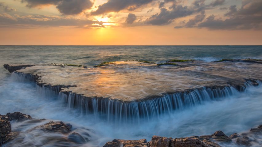 Seawater cascades over an ancient coral reef, Hang Rai, Vietnam