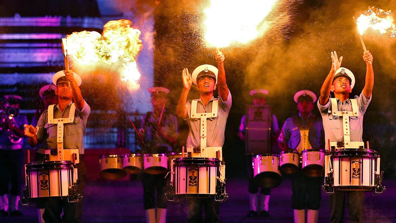 Indian Navy soldiers demonstrate their skills as they play drums during a rehearsal ahead of Navy Day