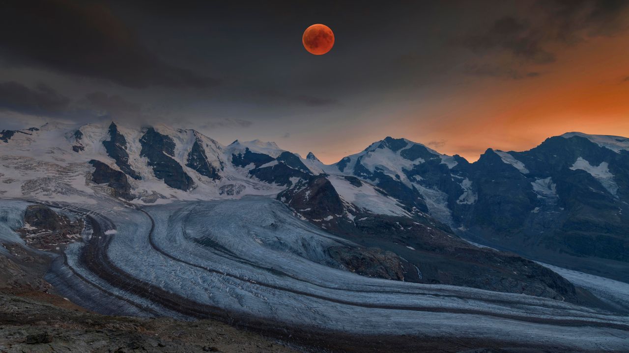 Panoramic view of the Bernina Range with blood moon, Eastern Alps, Engadin, Switzerland