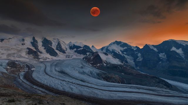 Panoramic view of the Bernina Range with blood moon, Eastern Alps, Engadin, Switzerland