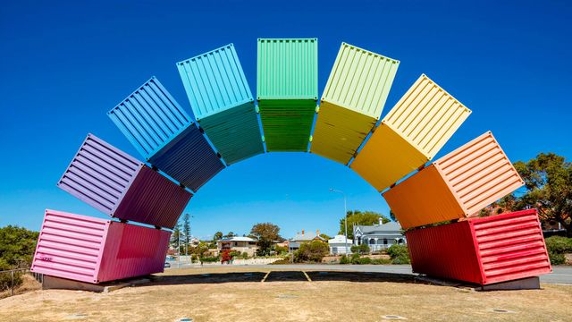 Wide angle view of rainbow-coloured shipping containers in Fremantle, Australia